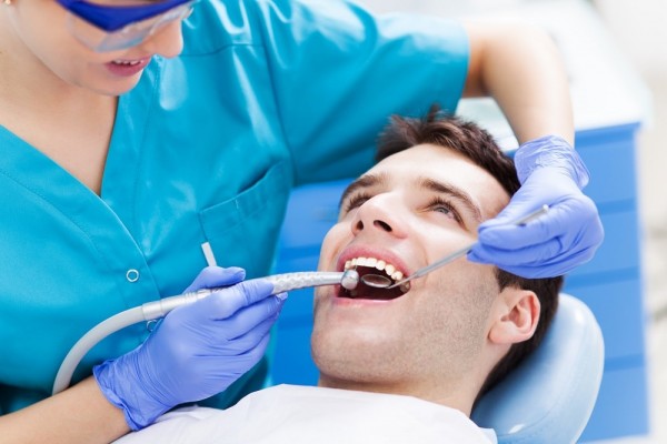 A young man gets his teeth cleaned